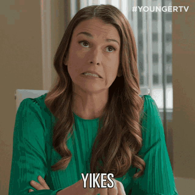 a woman in a green shirt says yikes