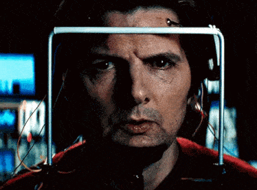 a close up of a man 's face with wires attached to it
