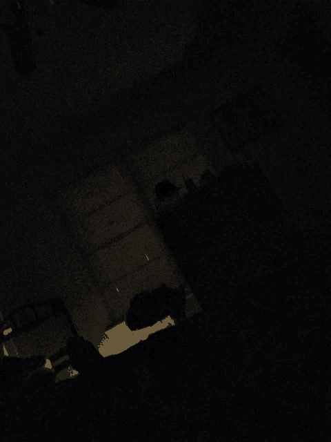 a dark room with a shadow of a person on the wall