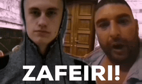 a man in a hoodie stands next to another man with the words zafeiri on the bottom