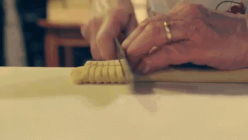 a person is cutting a banana with a knife