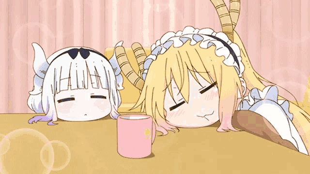 a couple of anime characters laying on a table with a cup of coffee