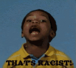 a young boy is wearing a yellow shirt that says that 's racist .