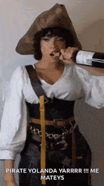 a woman in a pirate costume is drinking wine from a bottle .