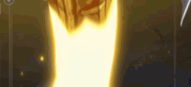a close up of a person 's hand with a yellow light coming out of it in a dark room .