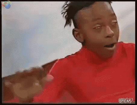 a man in a red shirt is making a funny face and the word break is on the screen
