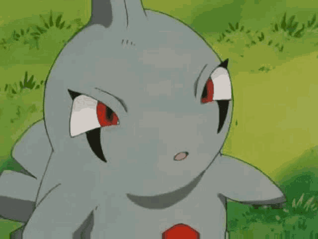 a cartoon shark with red eyes is sitting on top of a grass covered field .