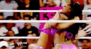 a pixelated image of a woman in a wrestling ring with a w live logo
