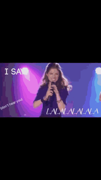 a woman singing into a microphone with the words " i say " on the bottom