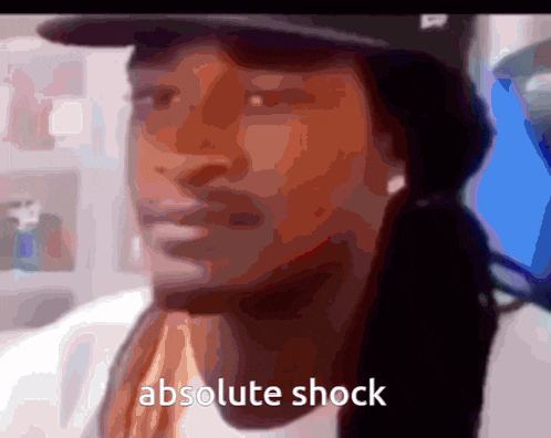 a man wearing a hat says absolute shock in a blurry photo