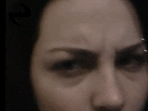 a close up of a woman 's face with the letter e above her eye