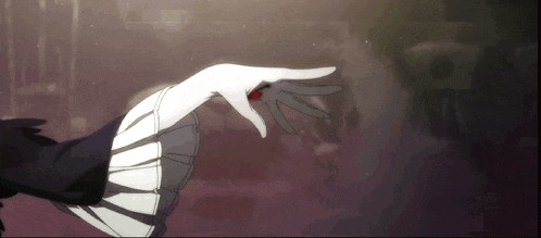 a woman 's hand with a red ring in it