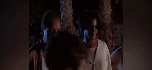 a man and a woman are standing next to each other and the man is saying cutie pie
