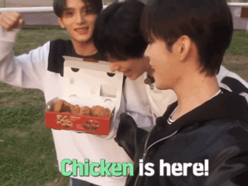 a man holding a box of chicken nuggets with the words chicken is here