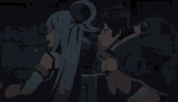 a boy and a girl are standing next to each other in the dark