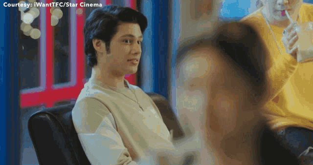 a man is sitting on a couch with the words courtesy i want tfc / star cinema written above him