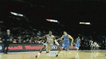a basketball game is being played in front of a sign that says audi warner