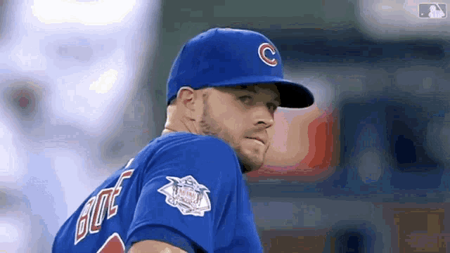 a baseball player wearing a blue uniform and a hat with the letter c on it