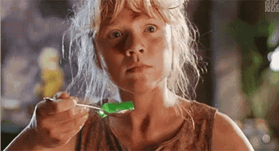 a girl is eating jelly with a spoon .
