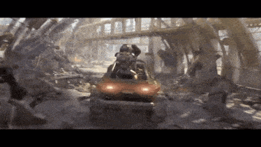 a man is driving a red vehicle through a ruined building