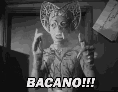 a black and white photo of a statue with a bat mask and the words bacano !!! .