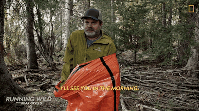 a man in a green jacket holding an orange bag that says i 'll see you in the morning