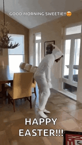 a person in a white bunny suit is dancing in a living room .