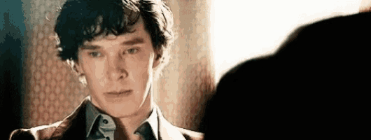 a close up of a man 's face looking at another man .