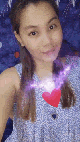 a woman is taking a selfie with a heart in her chest .
