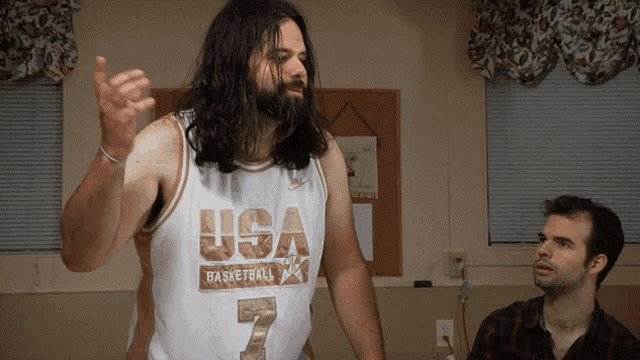 a man with long hair and a beard wearing a usa basketball jersey
