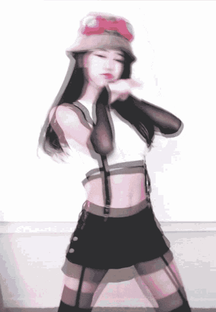 a woman wearing a hat and a crop top dancing