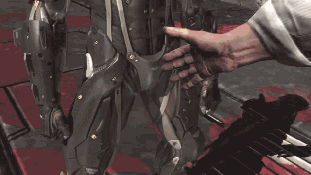 a man in a suit is holding a gun that says ' assault rifle ' on the side of it