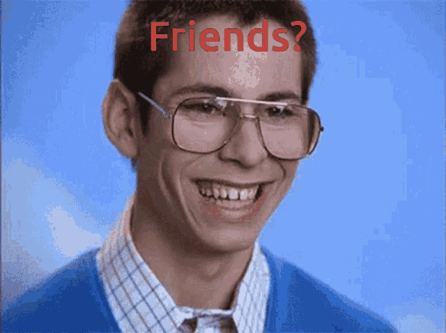 a man wearing glasses and a blue sweater is smiling with the words friends written on his forehead