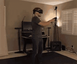 a man is wearing a virtual reality headset in a room