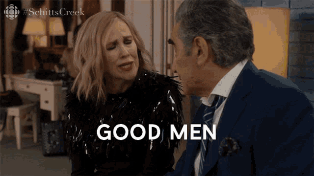 a man and woman are sitting next to each other and the man is saying good men