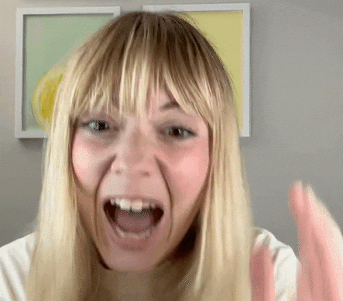 a woman with blonde hair and fringe is making a funny face with her mouth open .