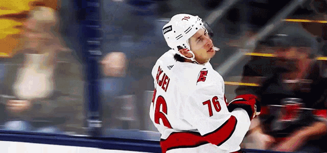 a hockey player wearing a number 76 jersey