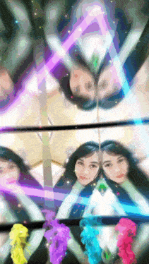 a woman 's face is reflected in a mirror