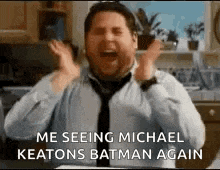 a man in a tie is screaming in a kitchen while wearing a shirt and tie .