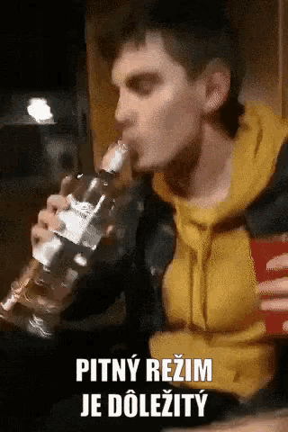a man drinking from a bottle with the words pitny režim je dolezity written below him
