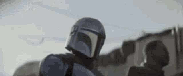 a close up of a person wearing a helmet standing in front of a building .