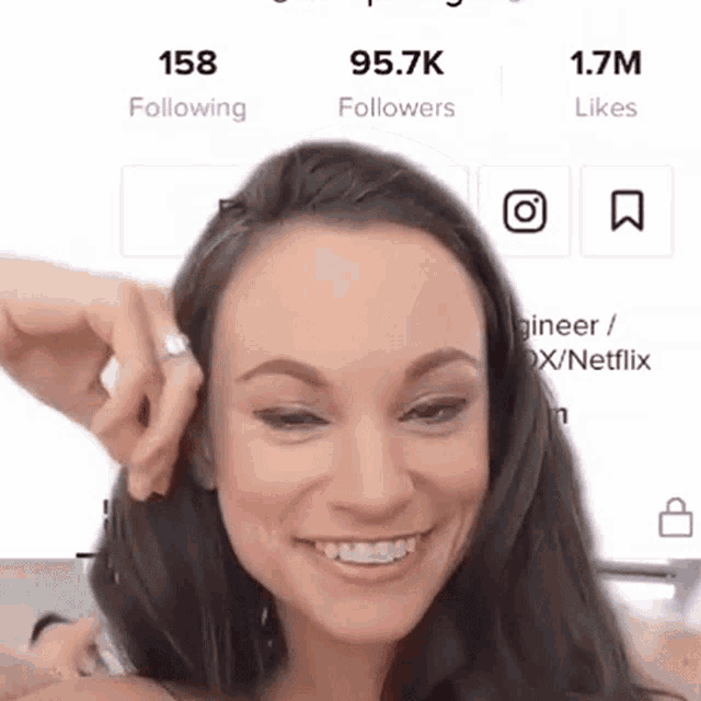 a woman with a ring on her finger is smiling and has 158 followers