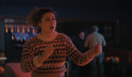 a woman is standing in a bowling alley with the word rude above her