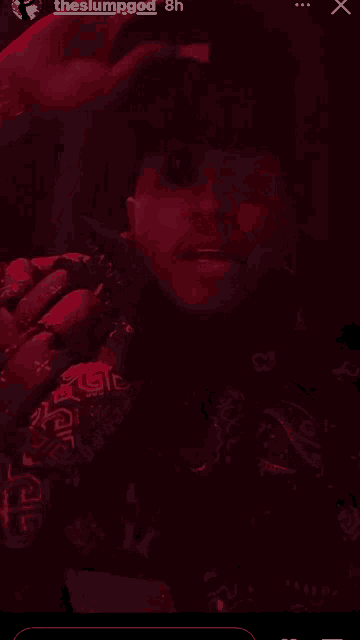 a man in a bandana is holding a microphone in a dark room with the slumpgod written on the bottom