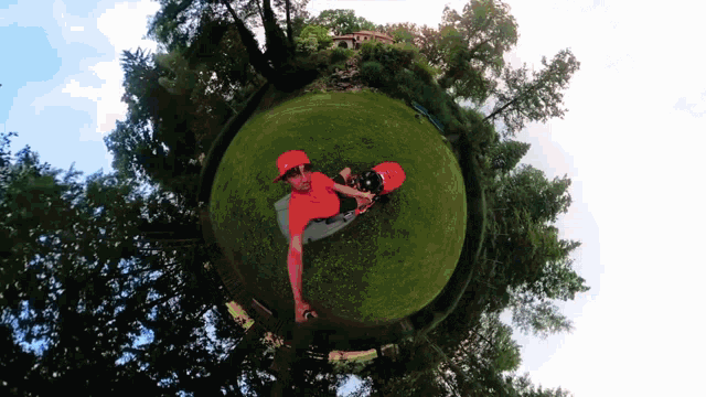 a man in a red hat is sitting on a globe