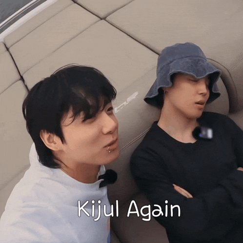 two men laying on a couch with the words kijul again written below them