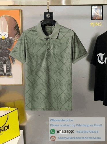 a green shirt is hanging on a hanger next to a fendi bag