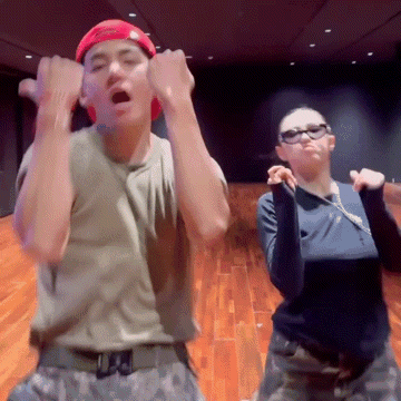 a man and a woman are dancing together and the man is wearing a hat that says supreme