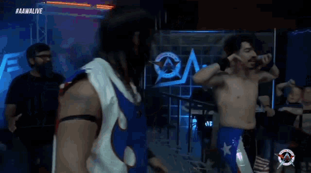 a man without a shirt is standing in front of a sign that says aawlive