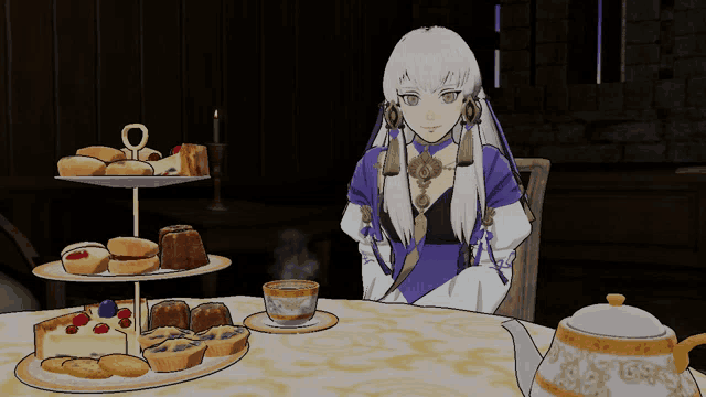 a woman sits at a table with a cup of tea and cakes